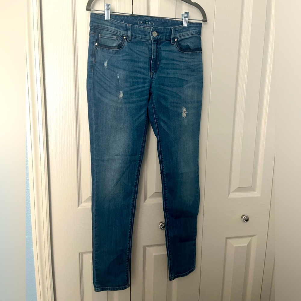 WHBM. Skinny jean with leather pocket detail. Medium wash. Size 4